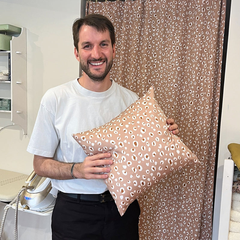 Participant à un atelier couture La Maison Naïve présentant son coussin cousu main