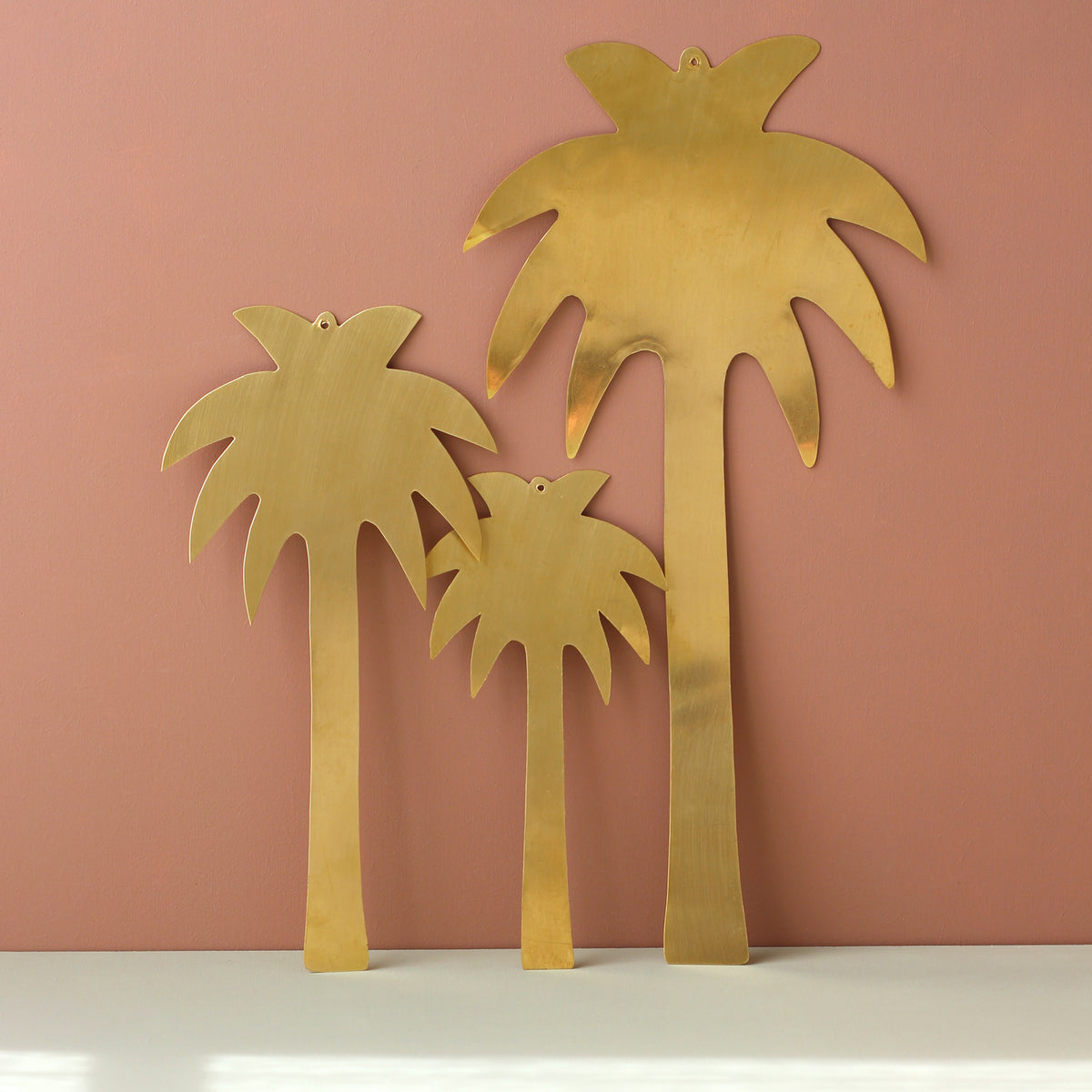 Ensemble de trois palmiers en laiton doré à accrocher en décoration murale